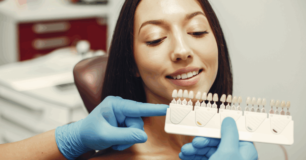 Smiling patient after cosmetic dentistry treatment at dental clinic