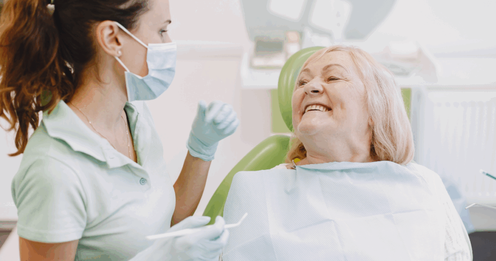 Senior smiling while receiving dental checkup for healthy teeth and gums