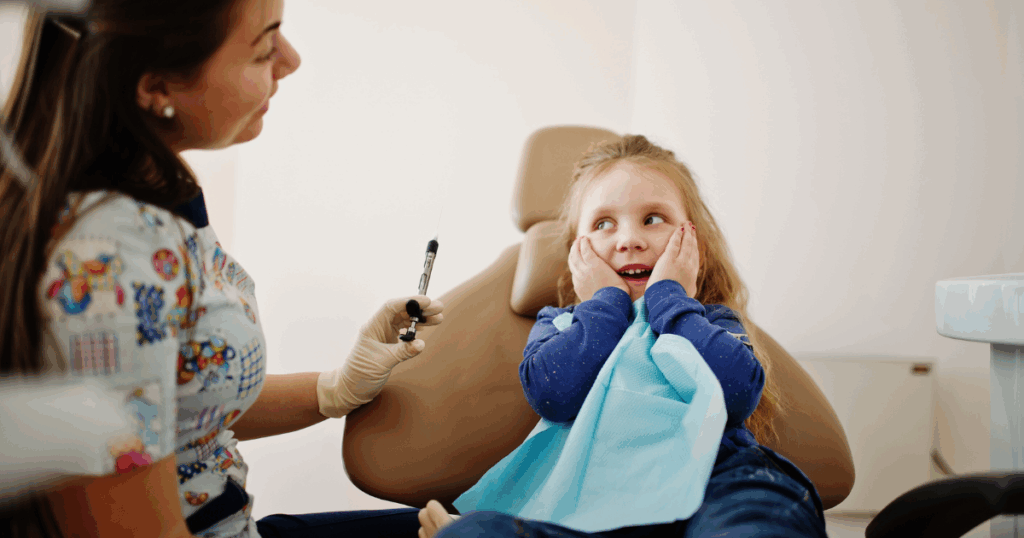 Dentist gently performing tooth extraction for a child