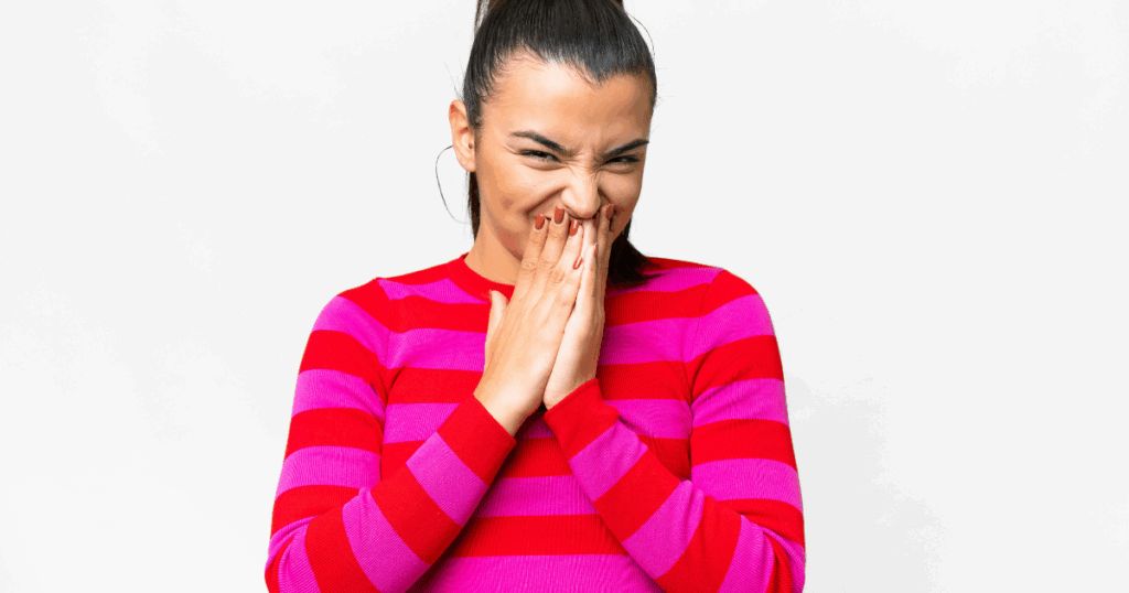 Woman covering her mouth due to bad taste