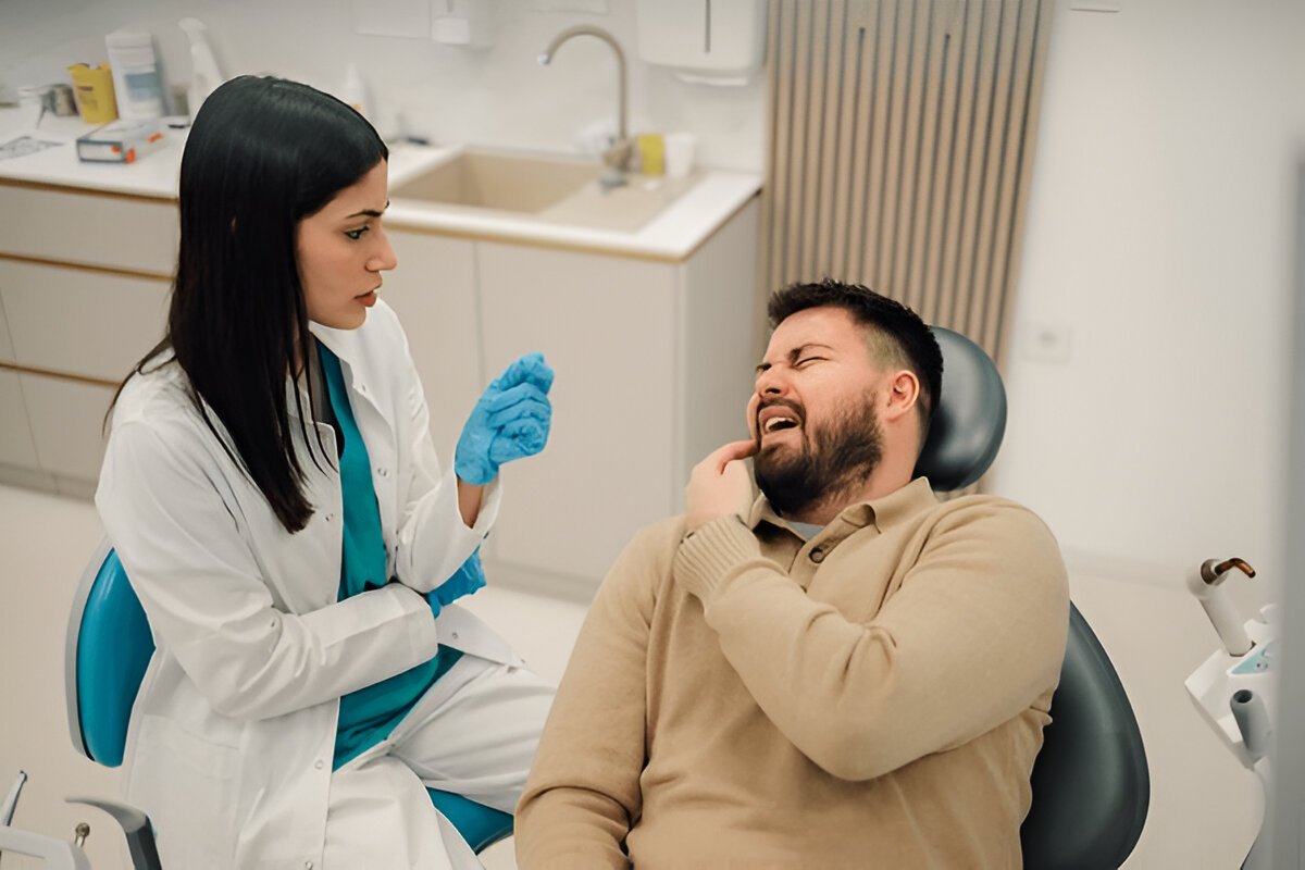 Dentist examining a patient with a dental infection at Gravity Dental Dubai