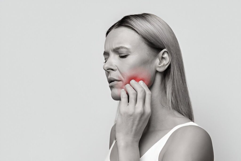 Woman waking up with jaw pain caused by sleep disorder at Gravity Dental
