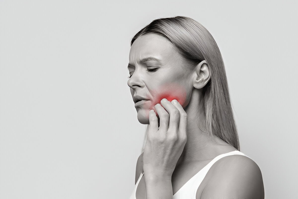 Woman waking up with jaw pain caused by sleep disorder at Gravity Dental