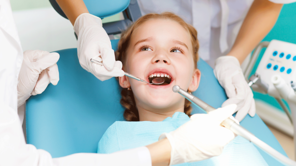 Child receiving a dental examination from a dentist in a clinic